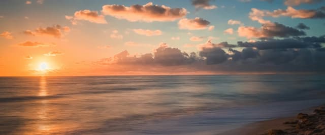 Warm golden sunset over the Gulf of Mexico, empty beach